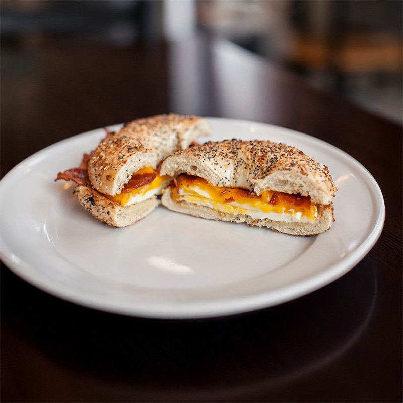 Fresh breakfast bagel sandwich with egg, cheese, and bacon at William family restaurant Brewed Awakenings in Williams, Arizona